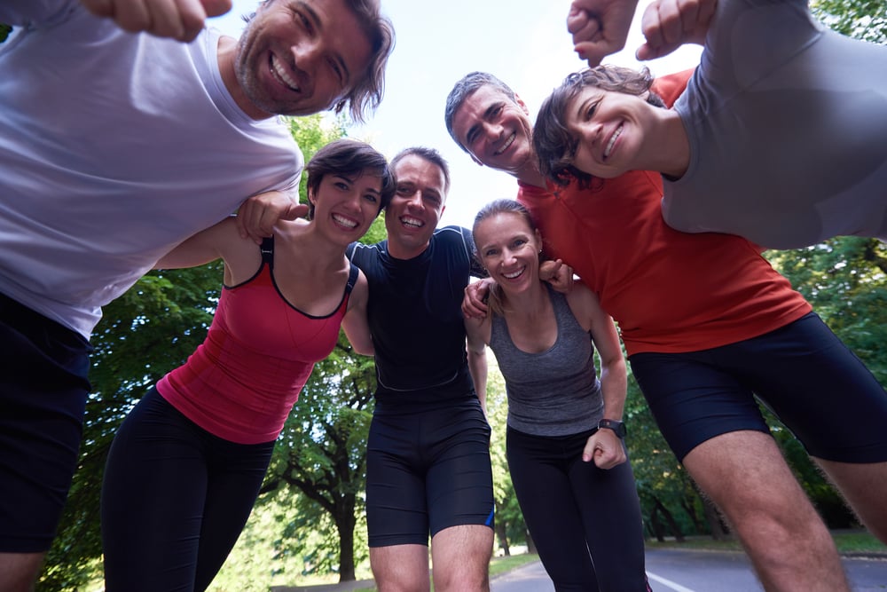 jogging people group, friends have fun,  hug and stack hands together after training